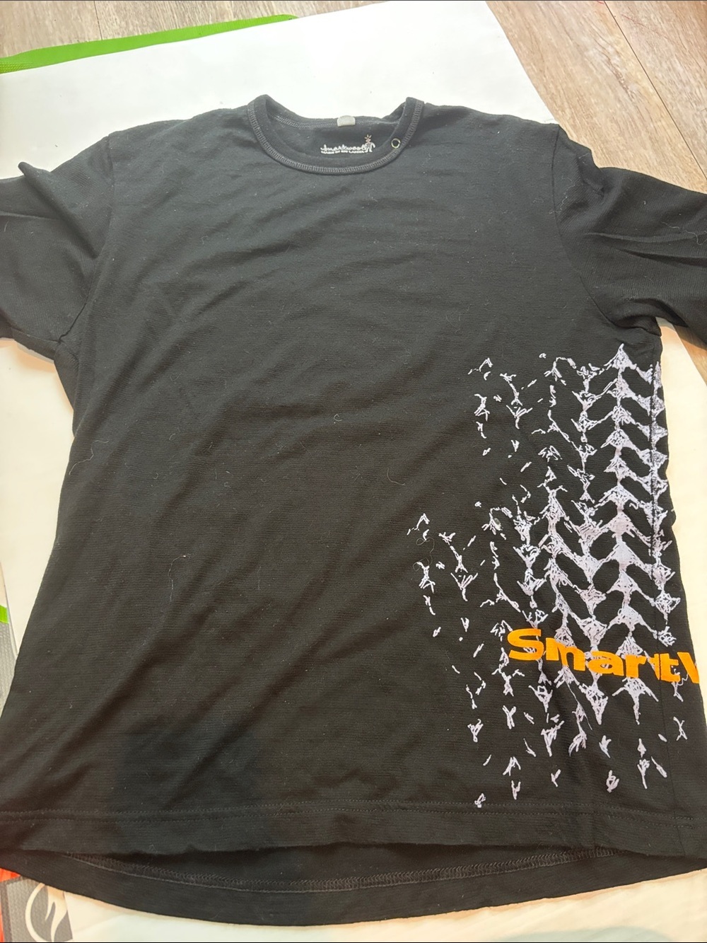 Smartwool Black Short-Sleeve Tee with White Tire-Track Graphic and Orange Logo